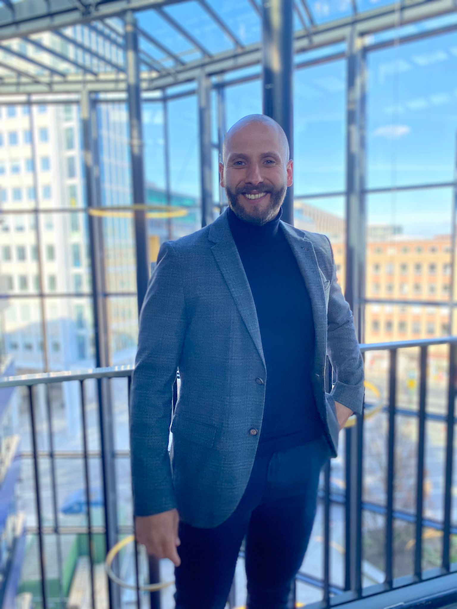 Andrej Marten, professional certified AVGS job coach, smiling confidently in business casual attire during coaching session